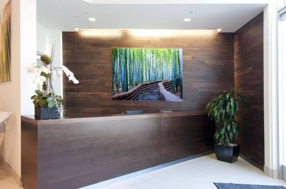 dark brown reception desk area with painting