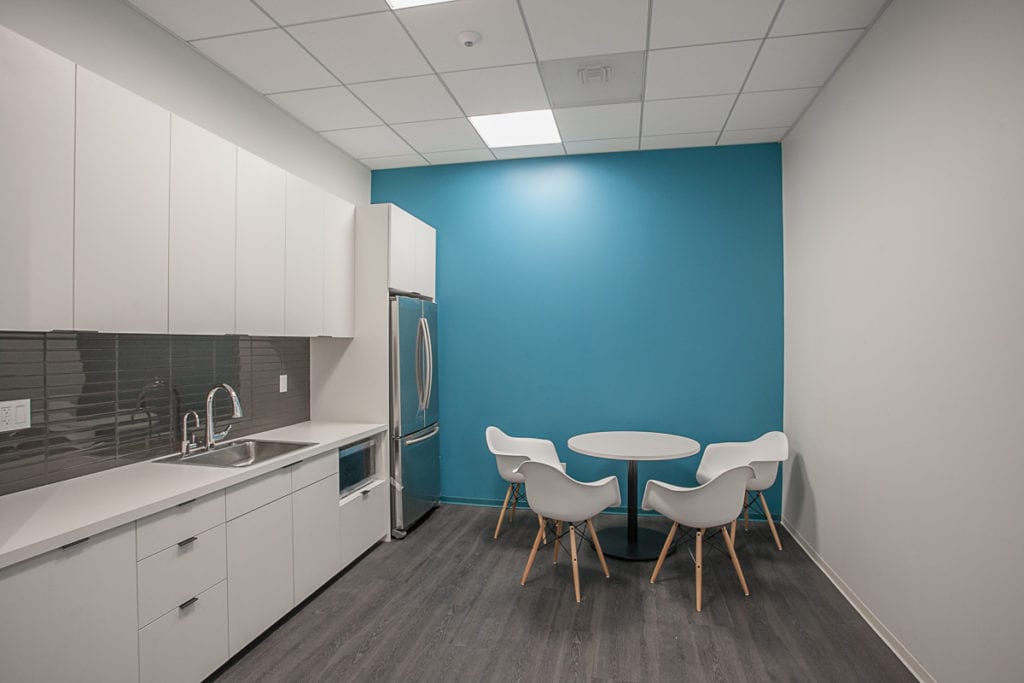White cabinet break room with blue wall