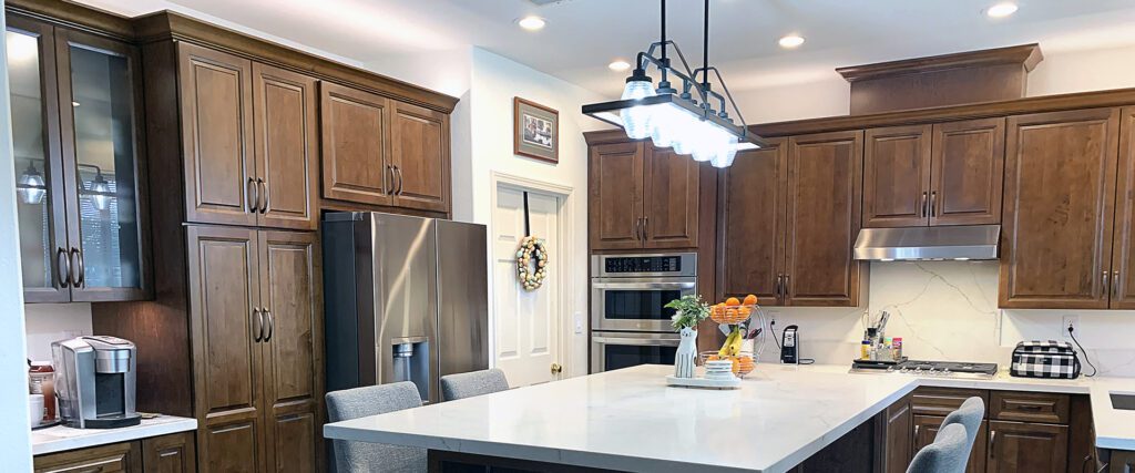 Pictured: Kraftmaid Vantage kitchen cabinets with a dark finish provide great contrast
